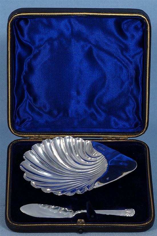 A cased Victorian silver scallop shaped butter dish and knife and a pair of butter dishes, 74 grams.